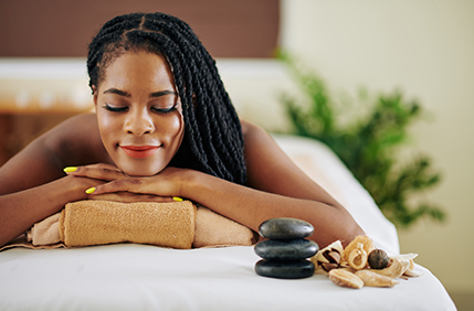 Woman relaxing with spa therapy and hot stone massage
